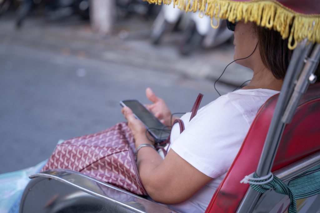 Tourists using AI voice technology during a guided travel experience.