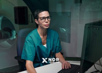 Medical professional using digital healthcare systems to support scalable healthcare innovation and improve clinical workflows.